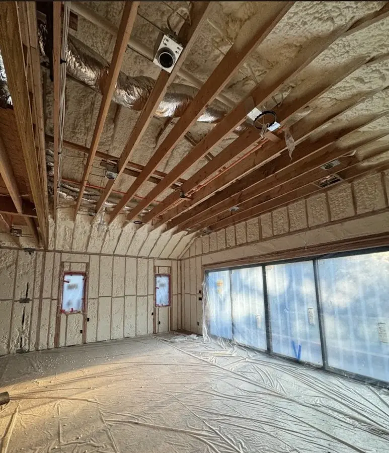 Interior walls and ceiling insulated with spray foam during new construction in Old Westbury